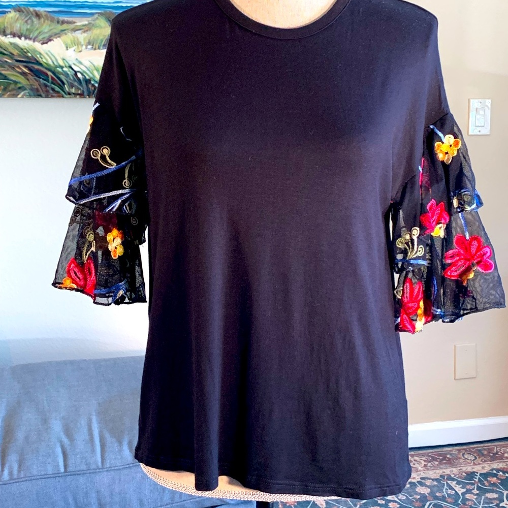 Black soft comfy T-shirt like fabric, with embellished ruffled sleeves